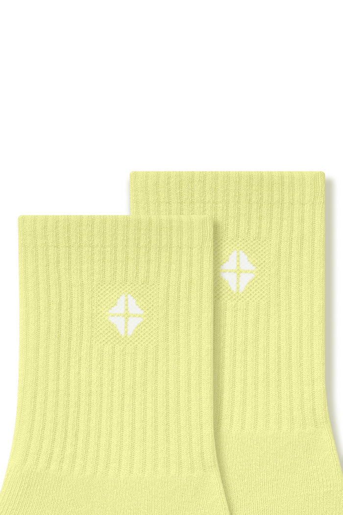 Top part of Adult Crew Socks in Citron with Kyte Baby logo on a white background
