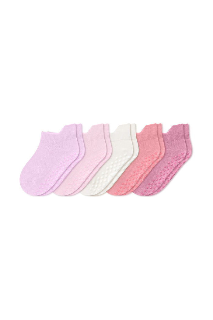 Six pairs of low-cut baby socks in pastel shades of pink, lavender, and white, arranged in a fan shape on a plain white background.