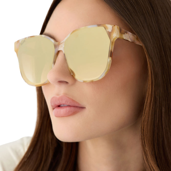 on model - female wearing diff eyewear gia oversized square sunglasses with a gilded tortoise acetate frame and brown gradient with light gold flash lenses detailed view