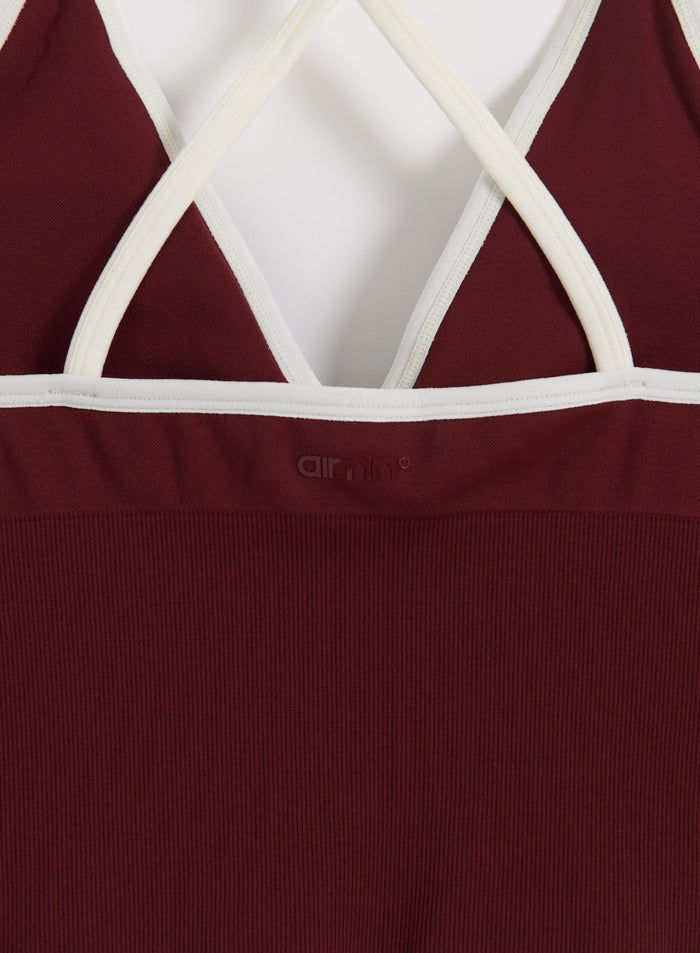 Merlot cross-back bralette with white straps and ribbed seamless fabric, featuring a tonal aim'n logo.