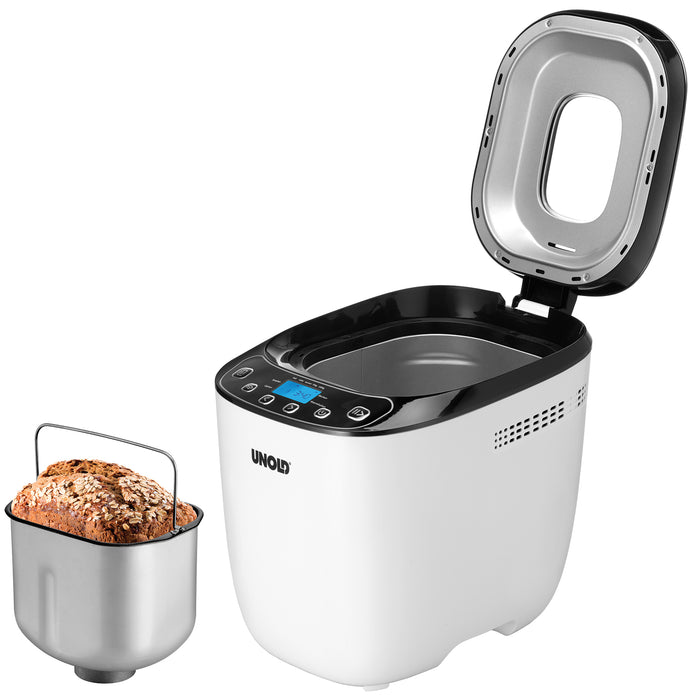 Ein geöffneter Unold AG 680101 Backmeister Design (B-Ware) Brotbackautomat in Weiß und Schwarz zeigt sein digitales Bedienfeld, neben einer herausnehmbaren Backform mit einem frischen Brotlaib.