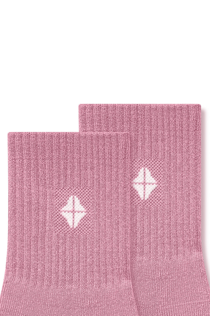 Top part of Adult Crew Socks in Apple Blossom with Kyte Baby logo on a white background