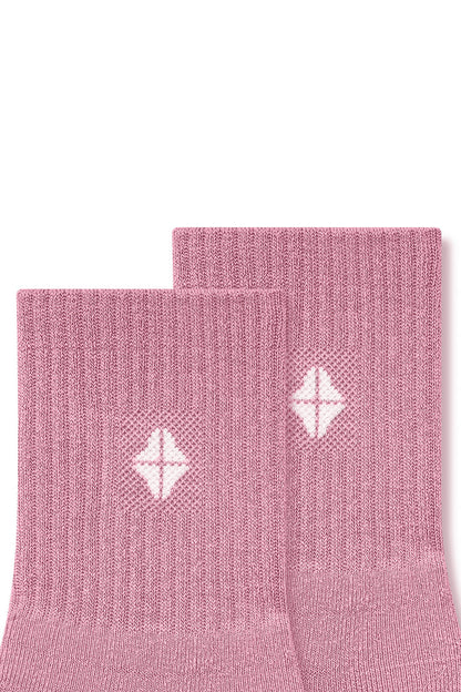 Top part of Adult Crew Socks in Apple Blossom with Kyte Baby logo on a white background