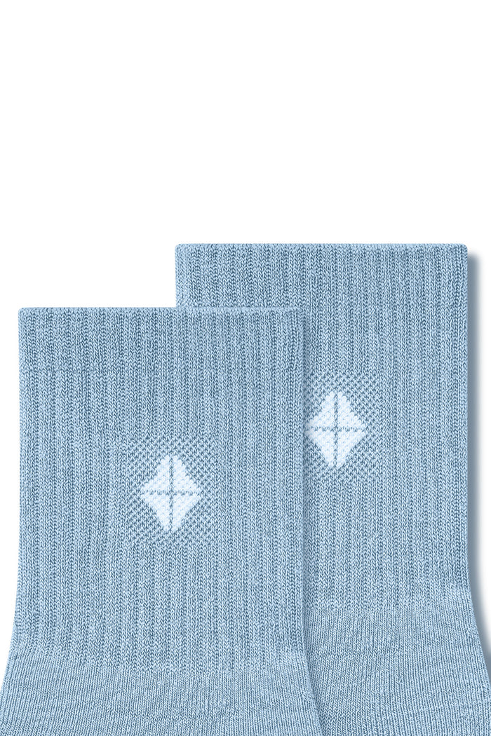 Top part of Adult Crew Socks in Breeze with Kyte Baby logo on a white background