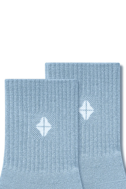 Top part of Adult Crew Socks in Breeze with Kyte Baby logo on a white background