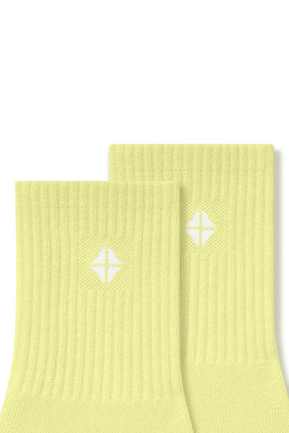 Top part of Adult Crew Socks in Citron with Kyte Baby logo on a white background