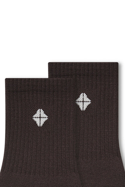 Top part of Adult Crew Socks in Espresso with Kyte Baby logo on a white background