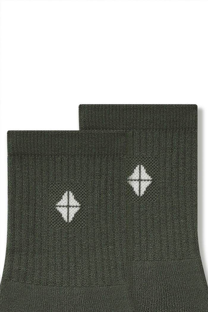 Top part of Adult Crew Socks in Fir with Kyte Baby logo on a white background