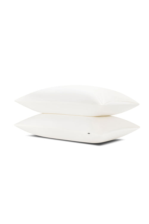 Two pillows stacked one on top of the other with the Bamboo Sateen Pillowcases in Shell on them