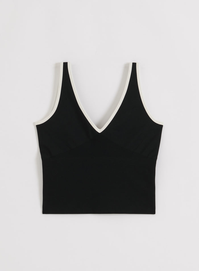 Cream Black aim'n Shape Seamless Deep Cut Singlet featuring a plunging V-neck and contrast trim.