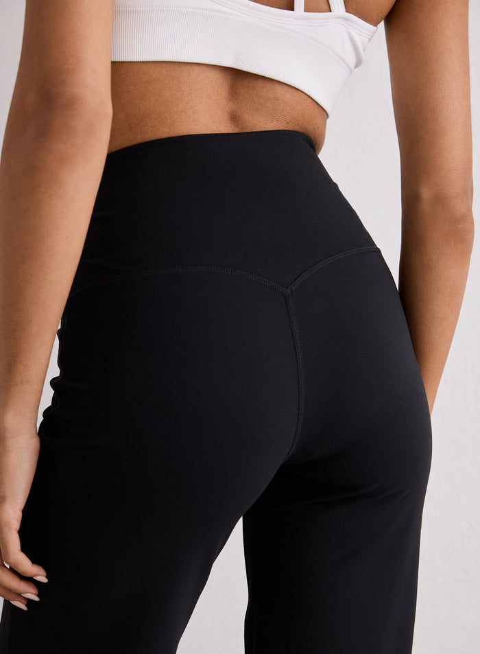 Close-up back view of the Black Sense Straight Leg Petite Tights showing the high waistband and V-shaped stitching