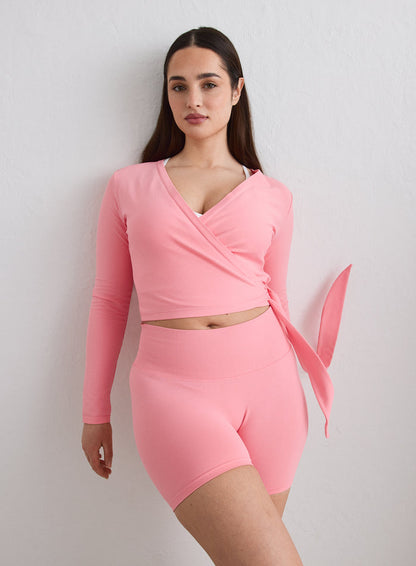 A model wearing a blush Shape Seamless Wrap Long Sleeve and matching shorts from aim'n [L-174cm]