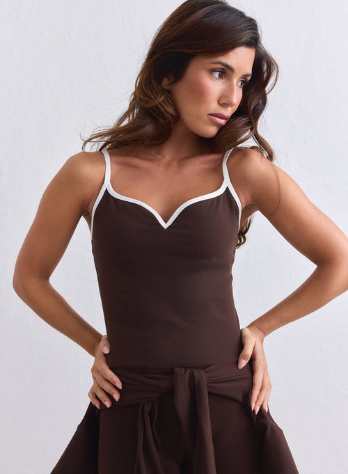Chocolate brown aim'n Sense Contour Singlet with white contrast piping and straps on a model. [S-165cm]