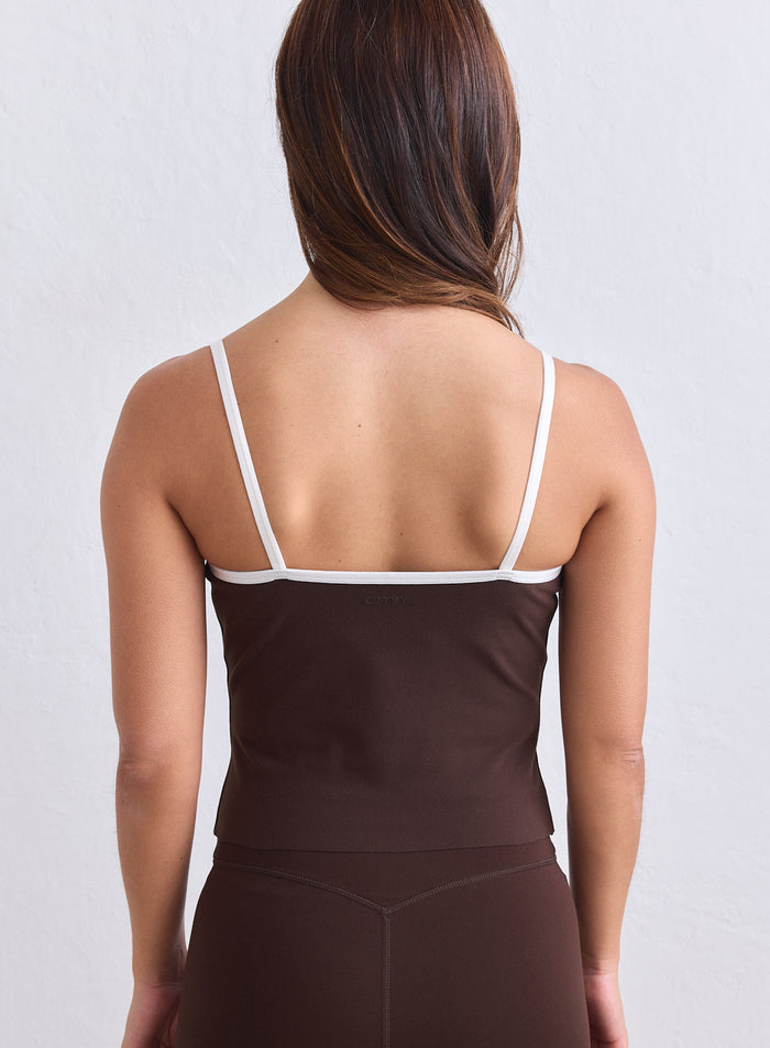 Back view of the aim'n chocolate brown singlet with slim white straps and back logo. [S-165cm]