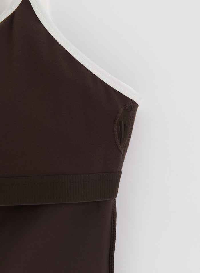Chocolate brown aim'n Sense Contour Singlet featuring white trim and mesh pockets for removable pads.