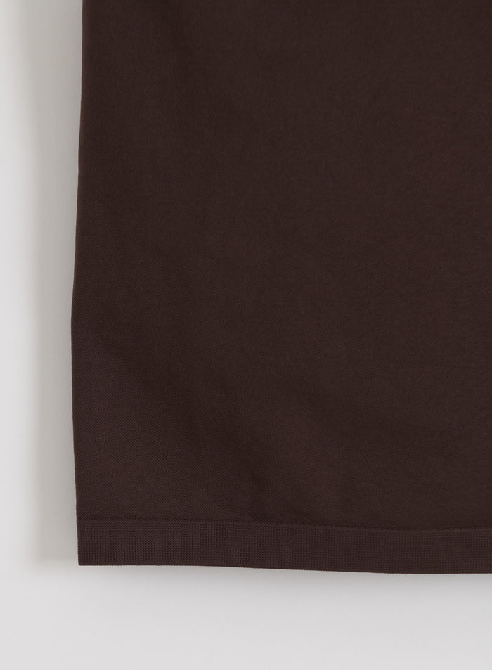 Close-up of the chocolate brown seamless fabric and hem of the aim'n Shape Seamless One Shoulder Bralette.