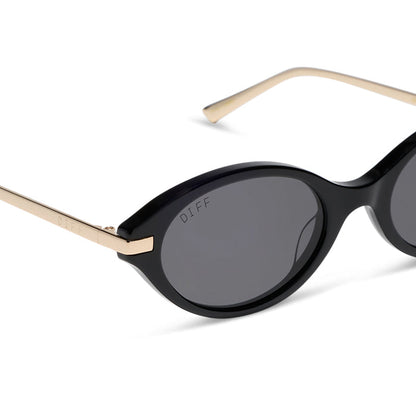 diff eyewear claudine oval sunglasses with a black acetate frame, gold metal temples and grey polarized lenses detailed view