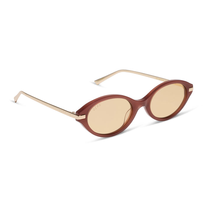 diff eyewear claudine oval sunglasses with a terracotta brown acetate frame, gold metal temples and champagne yellow tint lenses angled view