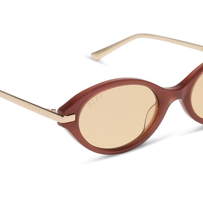 diff eyewear claudine oval sunglasses with a terracotta brown acetate frame, gold metal temples and champagne yellow tint lenses detailed view