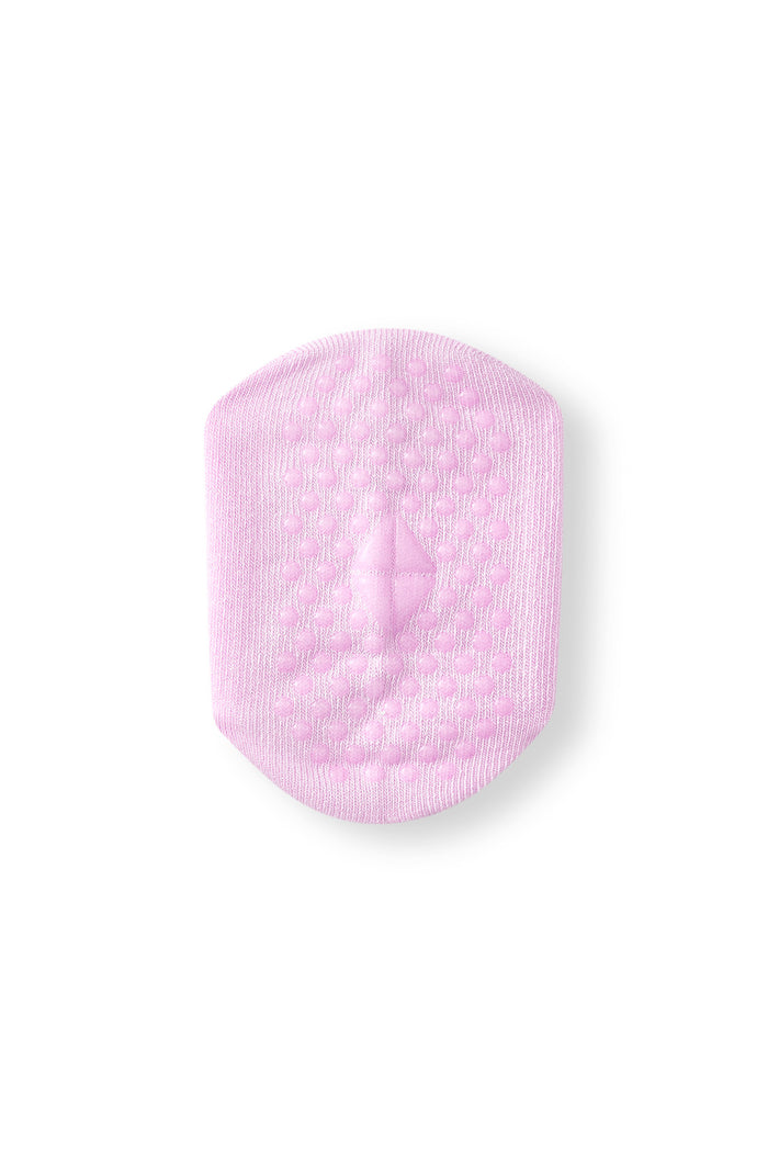 A single light pink textured non-slip sock with rounded corners, shown on a plain white background.