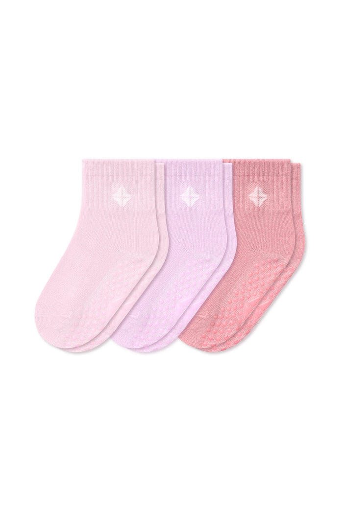Three pairs of baby socks in pastel shades of pink, light purple, and dusty rose, arranged side-by-side on a plain white background.