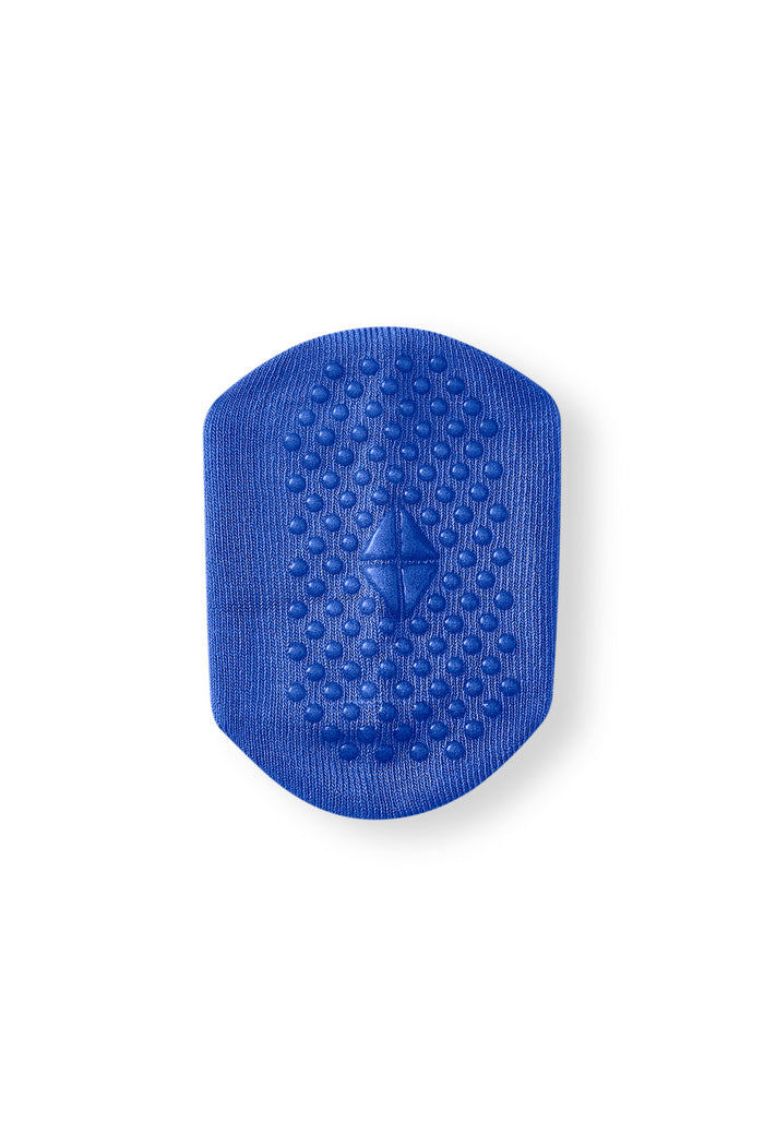 A blue textured silicone massage pad with a diamond-shaped center, shown on a plain white background.