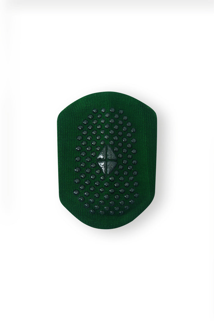 A dark green textured pad with a raised central diamond design, shown on a plain white background.