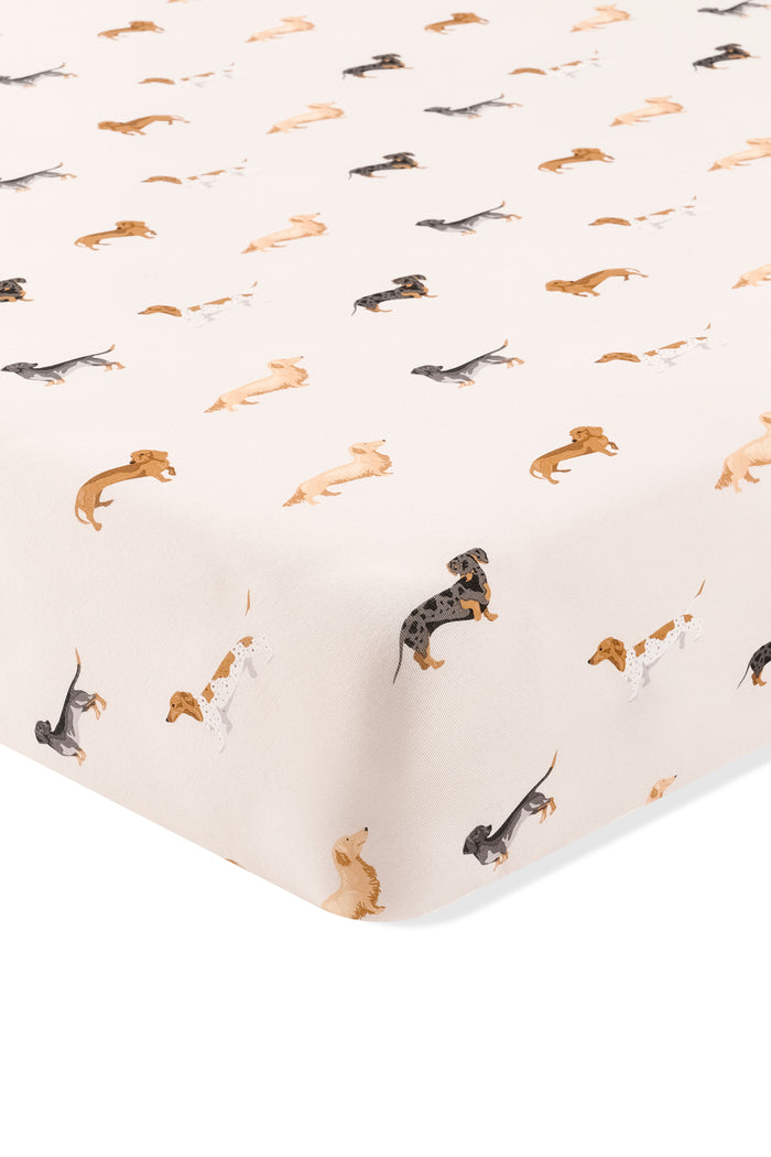 Beige Crib sheet with Dachshund print on a white background