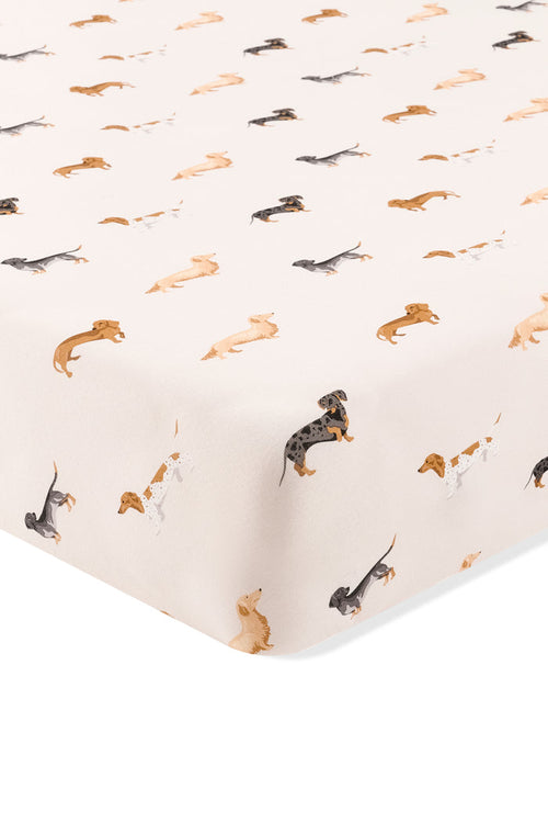 Beige Crib sheet with Dachshund print on a white background