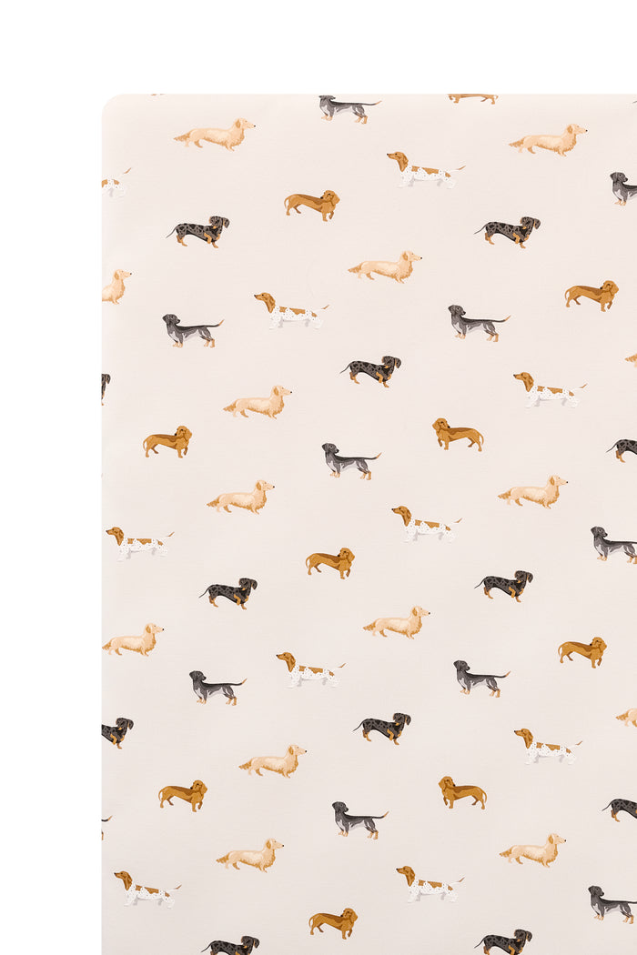 Beige Crib sheet with Dachshund print on a white background