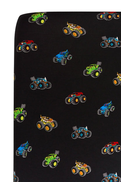 Close up of Crib Sheet with colorful Monster Truck print on white background