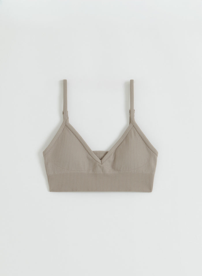 Flatlay of the Dark Clay Ribbed Seamless Deep Cut Bra from aim'n