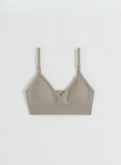 Flatlay of the Dark Clay Ribbed Seamless Deep Cut Bra from aim'n