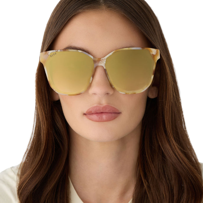 on model - female wearing diff eyewear gia oversized square sunglasses with a gilded tortoise acetate frame and brown gradient with light gold flash lenses front view