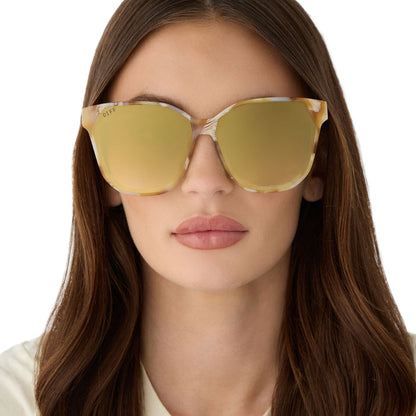on model - female wearing diff eyewear gia oversized square sunglasses with a gilded tortoise acetate frame and brown gradient with light gold flash lenses front view