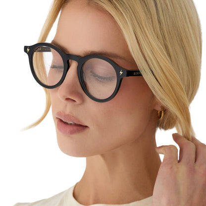 lifestyle - blonde female wearing diff eyewear x harry potter birthday round prescription glasses with a black acetate frame angled view