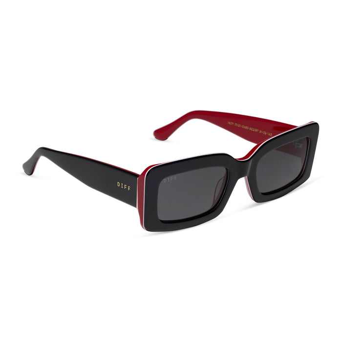 diff eyewear featuring the indy rectangle sunglasses with a black, white & red frame and grey polarized lenses angled view