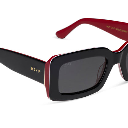 diff eyewear featuring the indy rectangle sunglasses with a black, white & red frame and grey polarized lenses detailed view