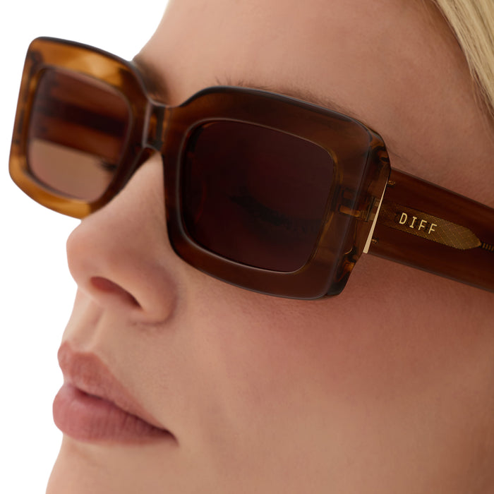 on model - blonde female wearing diff eyewear indy low profile square sunglasses with a tortoise acetate frame and brown lenses detailed view