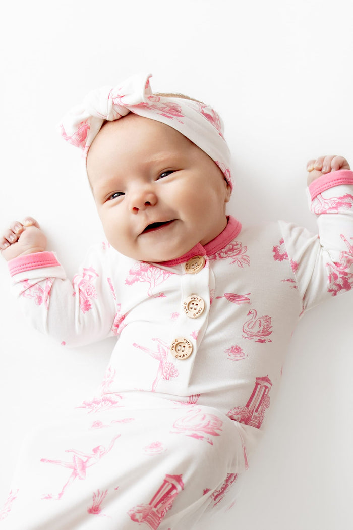 Close up of infant wearing the Knotted Gown with Bow Set in Toile Ballet