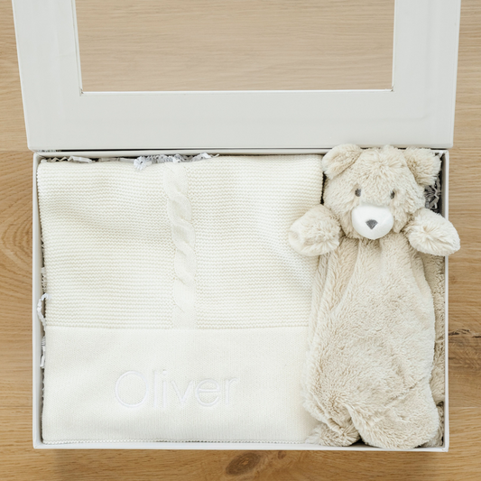 Timeless treasures with a curated baby gift box that comes with a beautiful receiving blanket and stuffed animal lovey.