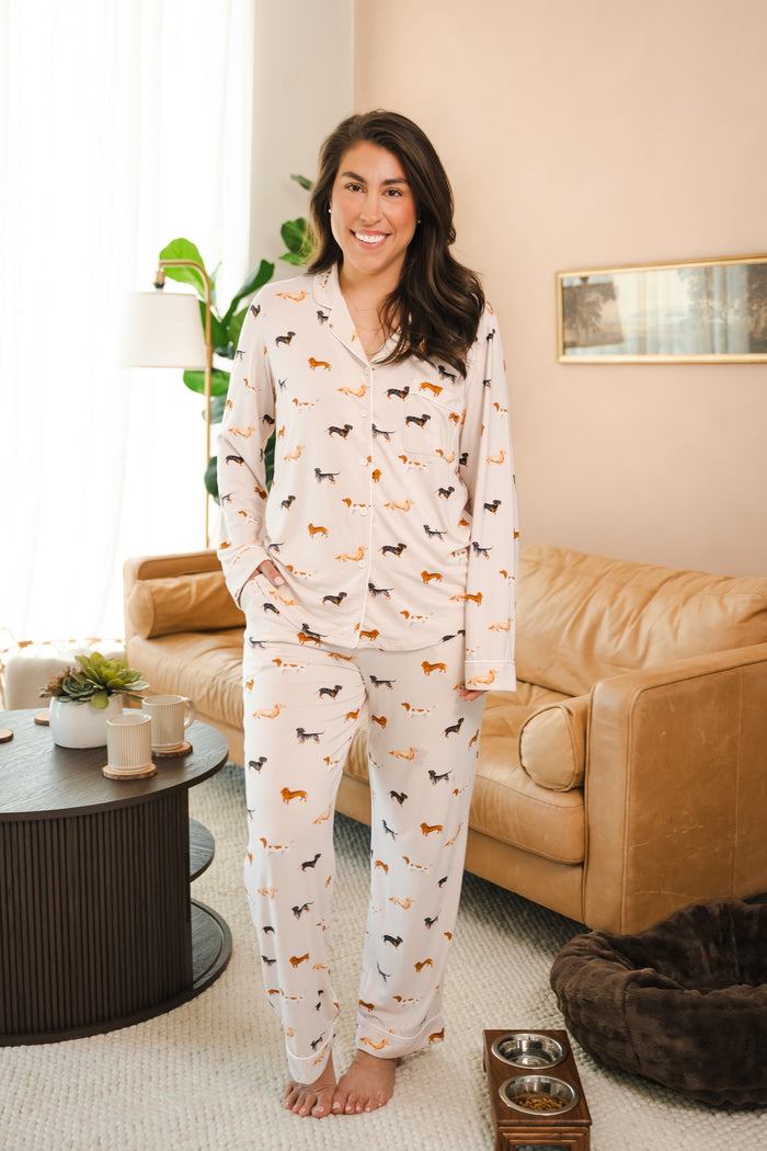 Model standing in a living room wearing a Beige Long-Sleeved Women's Pajama Set in Dachshund print