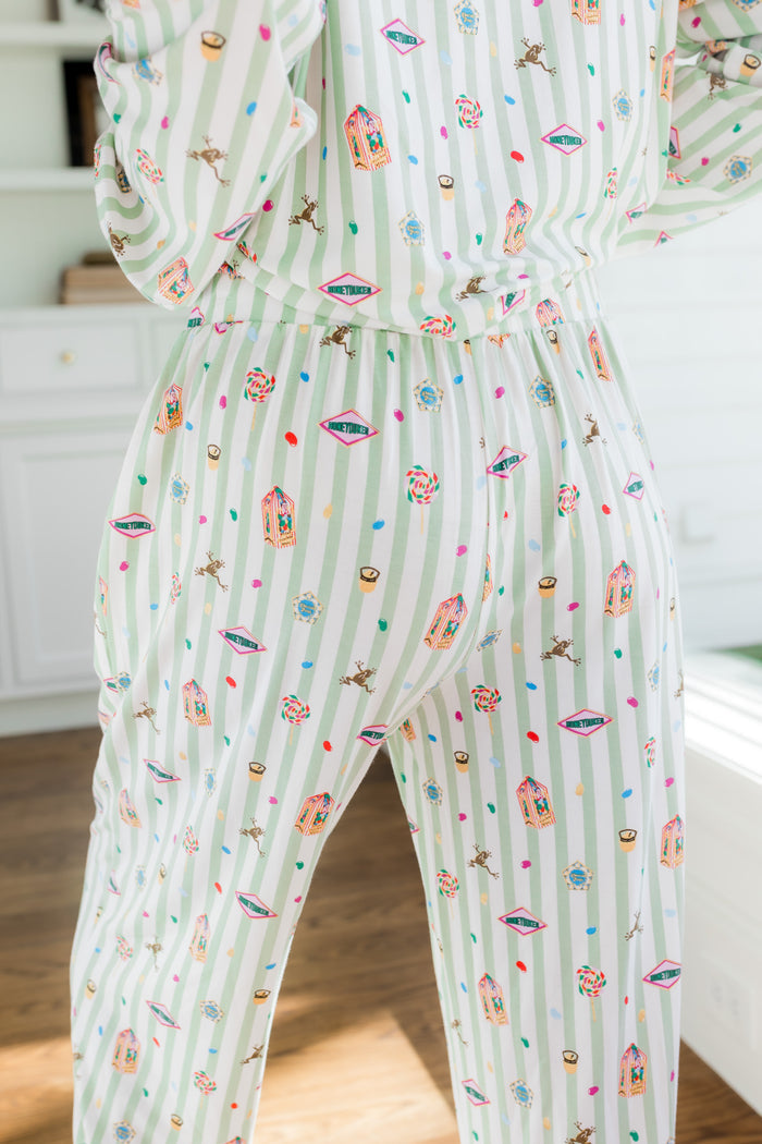 Back side of Long-Sleeved Women's Pajama Set pajamas with colorful Harry Potter patterns on a green and white striped fabric.