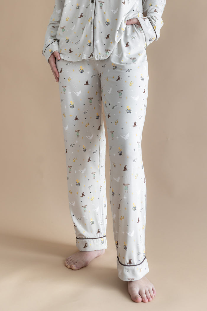 Person wearing a cream Long-Sleeved Women's Pajama Set pajama with Harry Potter prints on a beige background.