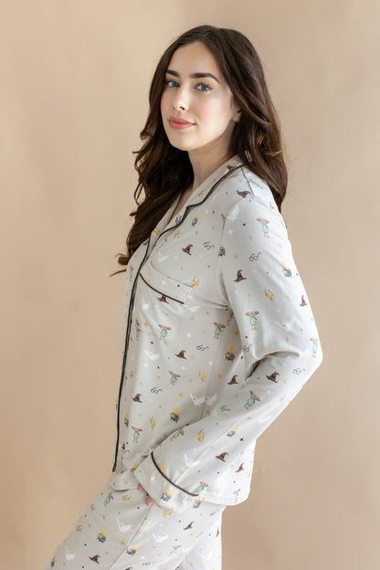 Side view of model wearing a cream Long-Sleeved Women's Pajama Set with Harry Potter prints on a beige background.