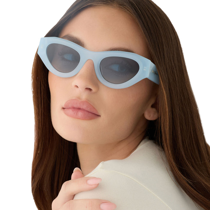 on model - female wearing for love & lemons diff eyewear featuring the lucy cat eye sunglasses with a pastel blue acetate frame and blue gradient polarized lenses angled view