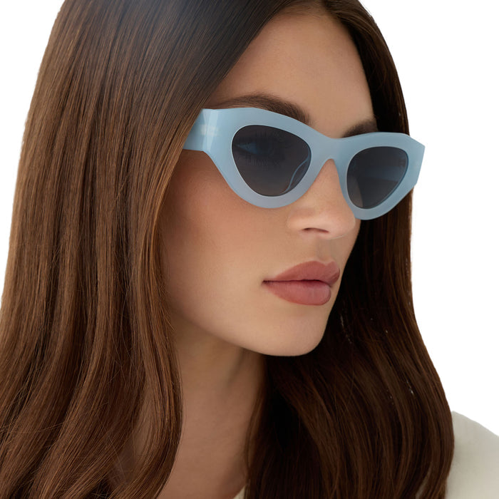 on model - female wearing for love & lemons diff eyewear featuring the lucy cat eye sunglasses with a pastel blue acetate frame and blue gradient polarized lenses detailed view