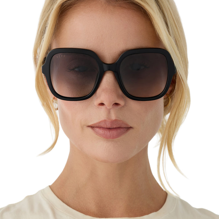 on model - blonde female wearing diff eyewera marlo square oversized sunglasses with a black acetate frame and grey gradient lenses front view