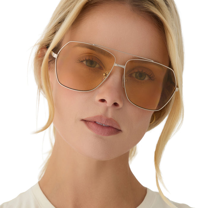 on model - blonde female wearing diff eyewear maude oversized aviator sunglasses with a gold metal frame and champagne yellow tint lenses front view