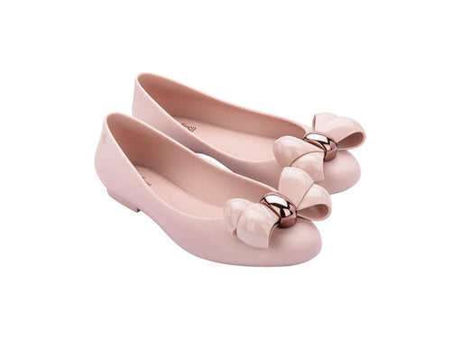 A pair of pink Melissa Doll VIII AD flat shoes with a maxi bow design on the top.